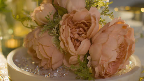 Close-Up-Of-Flowers-On-Table-Set-For-Meal-At-Wedding-Reception-In-Restaurant
